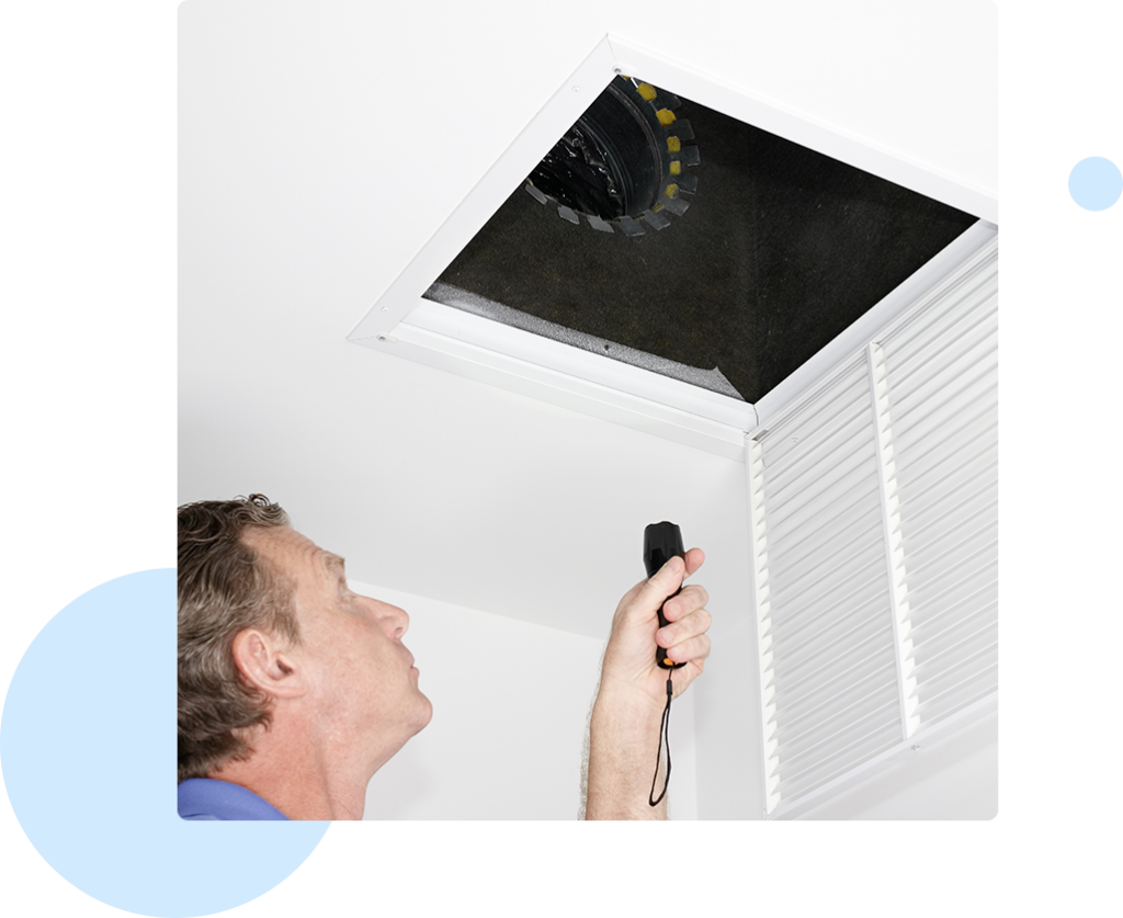 HVAC technician inspecting air ducts