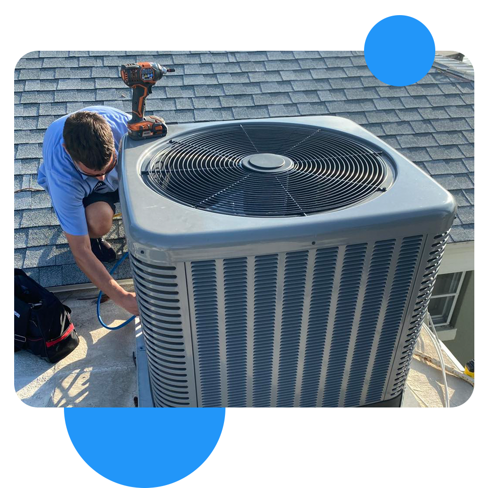 man working on a roof AC unit